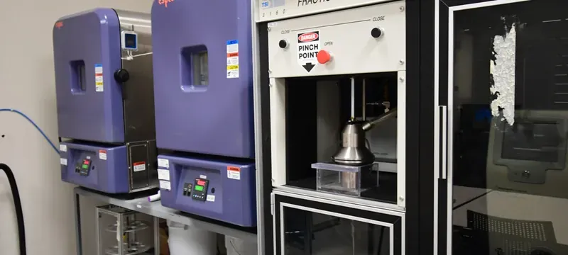 Engineer verifying a filter sample against tested standards in a laboratory
