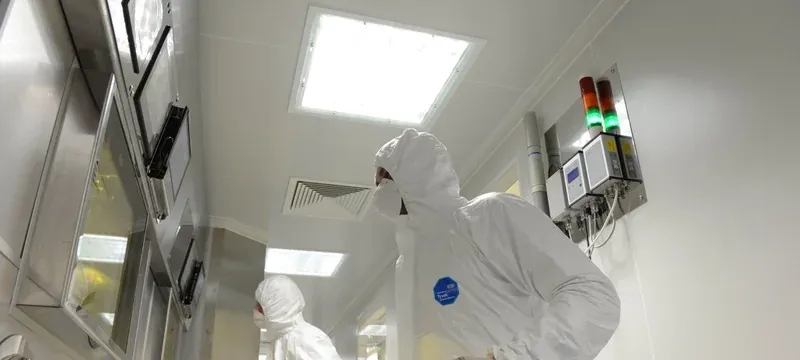 Technician handling a HEPA filter with gloves during safe replacement