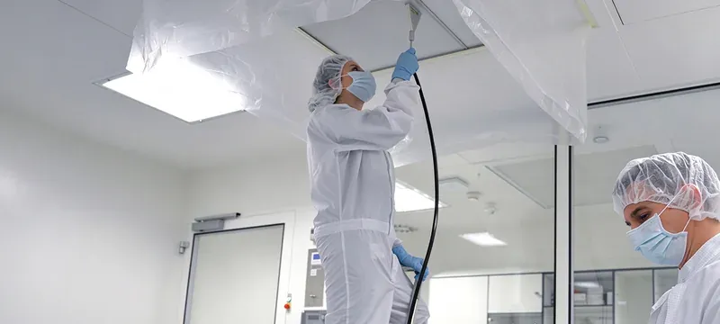 Technician performing HEPA filter leak test cleanroom