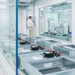 Technician adjusting Deiiang motorized zone dampers in a laboratory air system