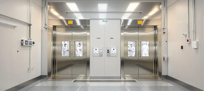 Interlocked automatic sliding doors at a cleanroom personnel access point after retrofit Interlocked automatic sliding doors at a cleanroom personnel access point after retrofit