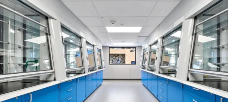 Low-flow VAV fume hood with a digital airflow control panel on a modern laboratory bench Low-flow VAV fume hood with a digital airflow control panel on a modern laboratory bench